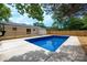 Backyard with an in-ground pool, wooden deck, and privacy fence, ideal for relaxing at 756 Logan St, Mooresville, NC 28115