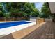 Inviting in-ground swimming pool with a nice wooden deck, perfect for summer fun at 756 Logan St, Mooresville, NC 28115