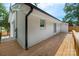 Exterior view of a brick home featuring a wooden deck for entertaining or relaxing at 756 Logan St, Mooresville, NC 28115