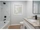 Modern bathroom featuring a white vanity, granite countertop, and tiled shower with black fixtures at 756 Logan St, Mooresville, NC 28115