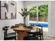 Stylish dining area with a view of the backyard pool through sliding glass doors at 756 Logan St, Mooresville, NC 28115