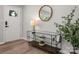 Modern entryway features hardwood floors, modern console table, and decorative mirror at 756 Logan St, Mooresville, NC 28115