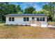Charming single-story home with a freshly painted white exterior and a welcoming light blue front door at 756 Logan St, Mooresville, NC 28115