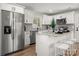 Modern kitchen with stainless steel appliances, granite countertops, and a breakfast bar at 756 Logan St, Mooresville, NC 28115