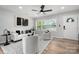 Bright living room with modern decor, hardwood floors, and large windows at 756 Logan St, Mooresville, NC 28115