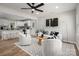 Open-concept living space featuring modern decor, hardwood floors, and bar stool seating to the kitchen at 756 Logan St, Mooresville, NC 28115