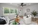 Bright living room with modern decor, hardwood floors, and large windows at 756 Logan St, Mooresville, NC 28115