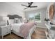 Bright main bedroom with hardwood floors, ceiling fan, and natural light at 756 Logan St, Mooresville, NC 28115