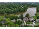 Stunning aerial view of homes situated along a picturesque lake surrounded by lush greenery at 9137 Brightleaf Pl, Charlotte, NC 28269