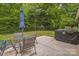 A backyard featuring a patio with dining furniture and a covered grill at 9137 Brightleaf Pl, Charlotte, NC 28269