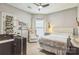 Cozy bedroom features a tufted headboard bed, neutral tones, and a cozy armchair. Perfect for relaxing at 9137 Brightleaf Pl, Charlotte, NC 28269
