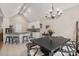 Dining area with dark wood table, bar seating, and stainless steel appliances under a vaulted ceiling at 9137 Brightleaf Pl, Charlotte, NC 28269