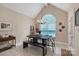 Vaulted ceiling dining area with chandelier, arched window, and a dark wooden table with bench seating at 9137 Brightleaf Pl, Charlotte, NC 28269