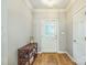 Entryway features hardwood floors and white trim with a wooden shelf to the side at 9137 Brightleaf Pl, Charlotte, NC 28269