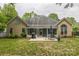 Back of house with patio, sunroom, grill, and landscaped yard at 9137 Brightleaf Pl, Charlotte, NC 28269