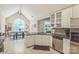 Bright kitchen with stainless steel appliances and granite countertops next to dining area under vaulted ceiling at 9137 Brightleaf Pl, Charlotte, NC 28269