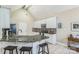 Bright kitchen featuring granite countertops, white cabinets, a breakfast bar, and stainless steel appliances at 9137 Brightleaf Pl, Charlotte, NC 28269