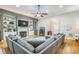 Bright and airy living room featuring a fireplace, built-in shelving, and a large sectional sofa at 9137 Brightleaf Pl, Charlotte, NC 28269