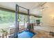 Bright sunroom with exercise equipment, desk, and outdoor views at 9137 Brightleaf Pl, Charlotte, NC 28269