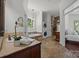Spacious bathroom featuring a soaking tub, tile shower, double vanities, and laundry at 9261 Marvin School Rd, Marvin, NC 28173