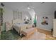 Bright bedroom with modern decor, an accent wall, and hardwood flooring at 9261 Marvin School Rd, Marvin, NC 28173