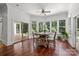 Bright breakfast nook featuring hardwood floors, large windows with backyard views, and a ceiling fan at 9261 Marvin School Rd, Marvin, NC 28173