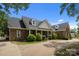 Charming stone-clad home with a columned front porch and manicured landscaping at 9261 Marvin School Rd, Marvin, NC 28173
