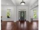 Elegant foyer featuring hardwood floors, a decorative front door, and abundant natural light from large windows at 9261 Marvin School Rd, Marvin, NC 28173