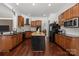 Well-equipped kitchen featuring custom cabinets, granite countertops, modern appliances, and a kitchen island at 9261 Marvin School Rd, Marvin, NC 28173