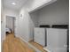 Bright laundry room with hardwood floors, a dryer and a washer at 9261 Marvin School Rd, Marvin, NC 28173