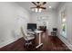 Home office featuring an adjustable desk, ceiling fan and natural light from a window at 9261 Marvin School Rd, Marvin, NC 28173