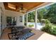 Outdoor patio with ceiling fan and columns, overlooking the pool at 9261 Marvin School Rd, Marvin, NC 28173