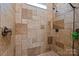 Close up of shower featuring neutral toned travertine walls with tile flooring at 9261 Marvin School Rd, Marvin, NC 28173