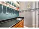 Unique bar area with glass shelving, dark countertops, and eye-catching wallpaper design at 9319 Chislehurst Rd, Mint Hill, NC 28227