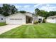 A cozy home with a two-car garage, a small porch with furniture, and a front lawn at 9319 Chislehurst Rd, Mint Hill, NC 28227