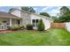 Close up of a front lawn and the side of a home with stone accents and manicured bushes at 9319 Chislehurst Rd, Mint Hill, NC 28227