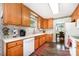 Functional kitchen with light wood cabinets and white appliances, adjacent dining nook at 9319 Chislehurst Rd, Mint Hill, NC 28227
