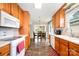 Open-concept kitchen with wooden cabinets and view to dining area at 9319 Chislehurst Rd, Mint Hill, NC 28227