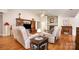 Spacious living room with a stone fireplace, vaulted ceiling, hardwood floors, and a ceiling fan at 9319 Chislehurst Rd, Mint Hill, NC 28227