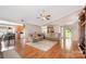 Open-concept living room showcasing hardwood floors and seamless flow to dining and kitchen at 9319 Chislehurst Rd, Mint Hill, NC 28227