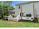 Exterior of home with a spacious wooden deck and outdoor seating area, surrounded by grass at 1003 Snake River Ct, Monroe, NC 28110