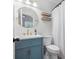 Bright bathroom featuring a modern blue vanity, gold fixtures, and floating shelves at 1003 Snake River Ct, Monroe, NC 28110