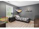 Cozy bedroom featuring a gray color scheme, plenty of toys, and natural light from a window at 1003 Snake River Ct, Monroe, NC 28110