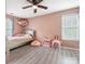 Adorable pink bedroom featuring a twin bed, ceiling fan, and playful decor perfect for a room at 1003 Snake River Ct, Monroe, NC 28110