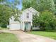 Charming two-story home with light blue siding, well-manicured lawn, and inviting curb appeal at 1003 Snake River Ct, Monroe, NC 28110