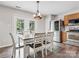 Inviting kitchen with stainless steel appliances, light wood cabinets, and a dining table with seating for six at 1003 Snake River Ct, Monroe, NC 28110