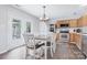Inviting kitchen with stainless steel appliances, light wood cabinets, and a dining table with seating for six at 1003 Snake River Ct, Monroe, NC 28110