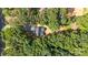 Aerial view of a secluded house surrounded by dense trees and lush greenery at 1004 E Sandy Ridge Rd, Monroe, NC 28112