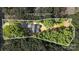 Aerial view of a property, surrounded by lush greenery and mature trees with a defined property line at 1004 E Sandy Ridge Rd, Monroe, NC 28112