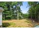 Large backyard with manicured lawn and mature trees, ideal for entertaining and recreation at 1004 E Sandy Ridge Rd, Monroe, NC 28112